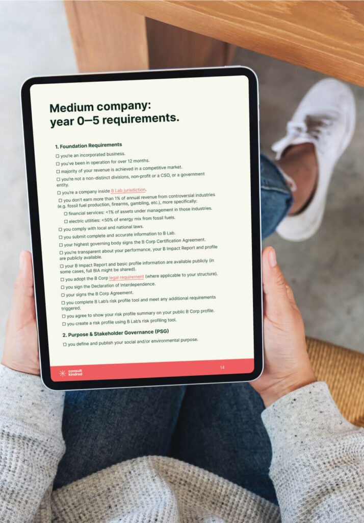 A lady reading checklist document on her tabler B Corp