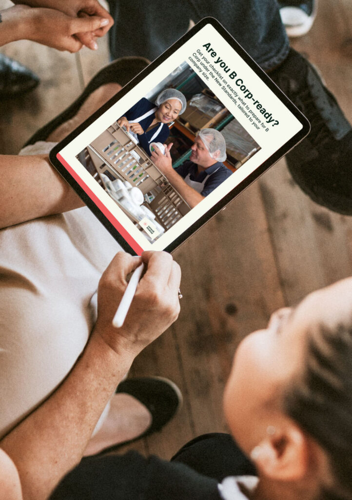 a group of business people checking out a pdf about B Corp checklist on tablet